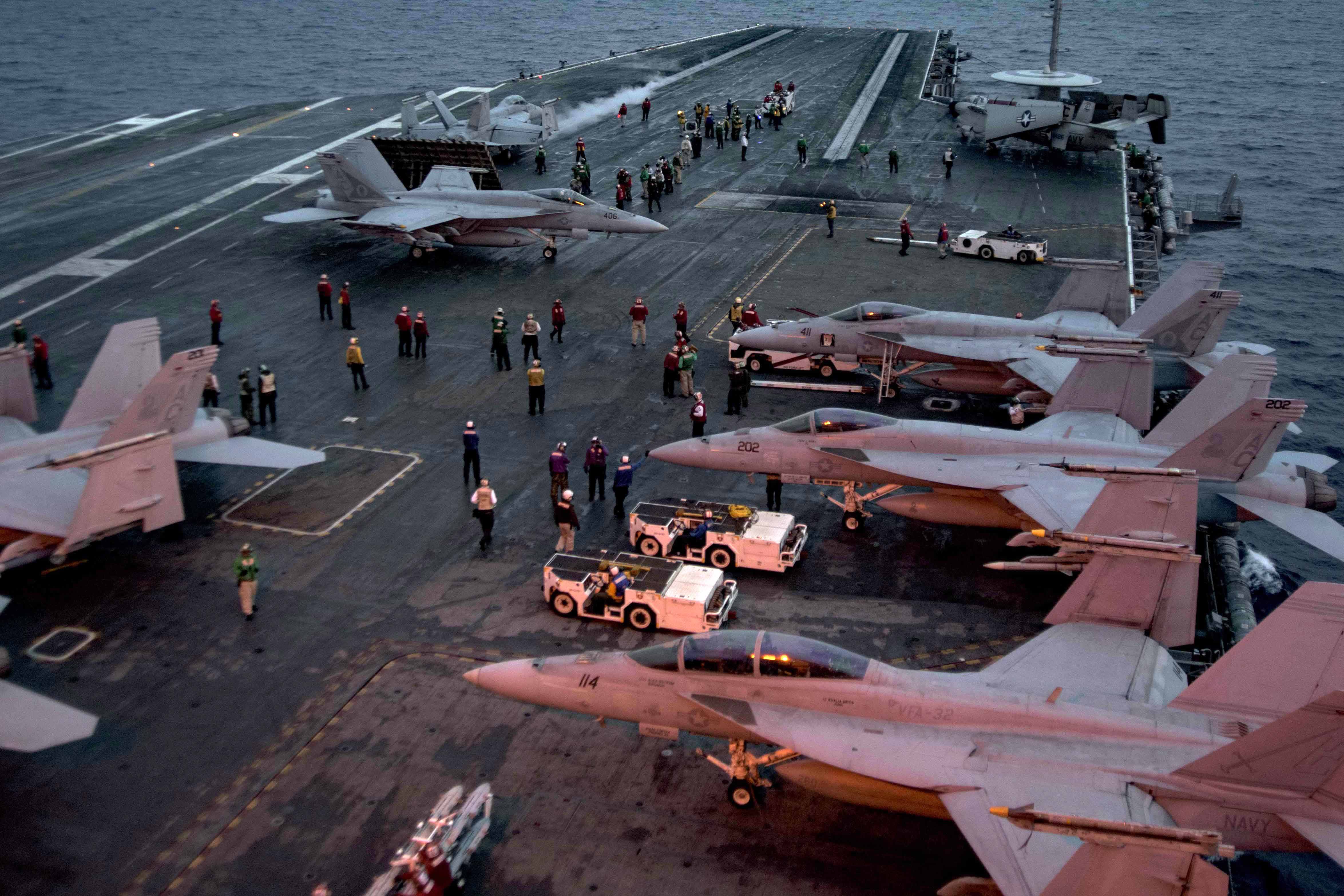 Busy carrier deck with aircraft in movement