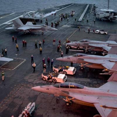 Busy carrier deck with aircraft in movement